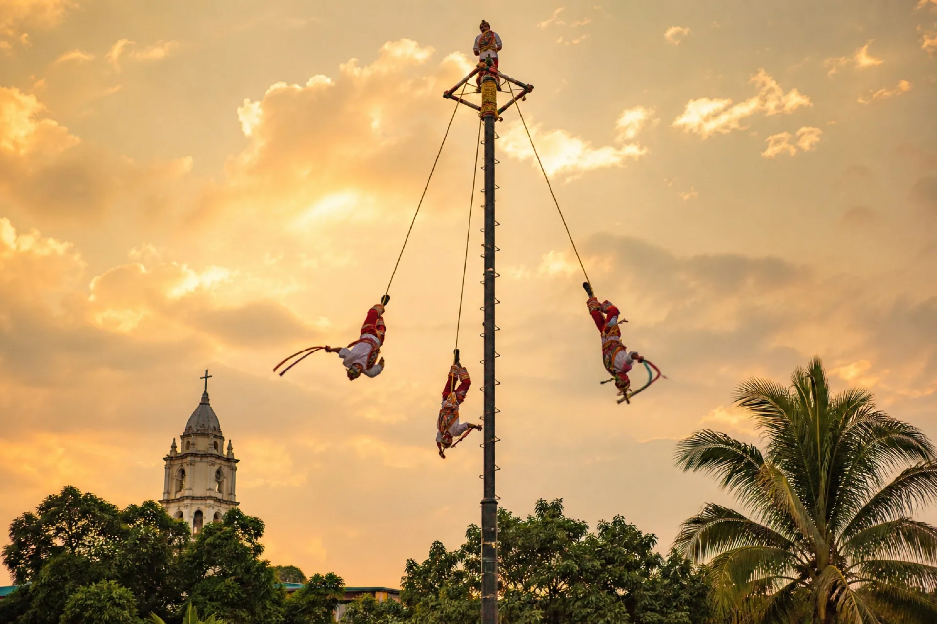 Voladores de Papantla girando en el palo ceremonial.